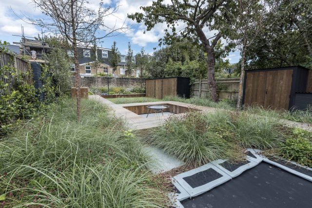 Garden designer contemporary family garden Chiswick friendly space decking, dining table, an aluminum pergola in powder-coated finish, a cozy and warm outlook.