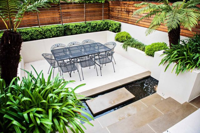 Beautiful London Garden, Clancarty Road, London, new block rendered boundary walls, planting, lighting, submersible water lights, bright contemporary effect.