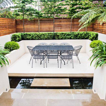 Beautiful London Garden, Clancarty Road, London, new block rendered boundary walls, planting, lighting, submersible water lights, bright contemporary effect.