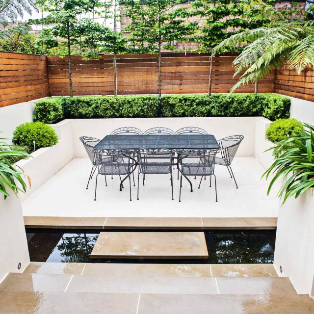 Beautiful London Garden, Clancarty Road, London, new block rendered boundary walls, planting, lighting, submersible water lights, bright contemporary effect.