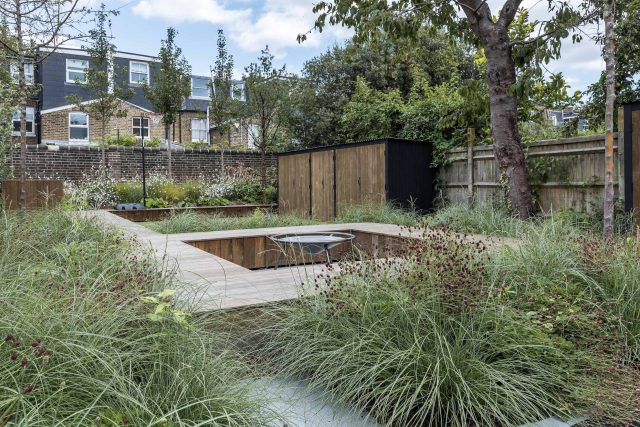 Garden designer contemporary family garden Chiswick friendly space decking, dining table, an aluminum pergola in powder-coated finish, a cozy and warm outlook.