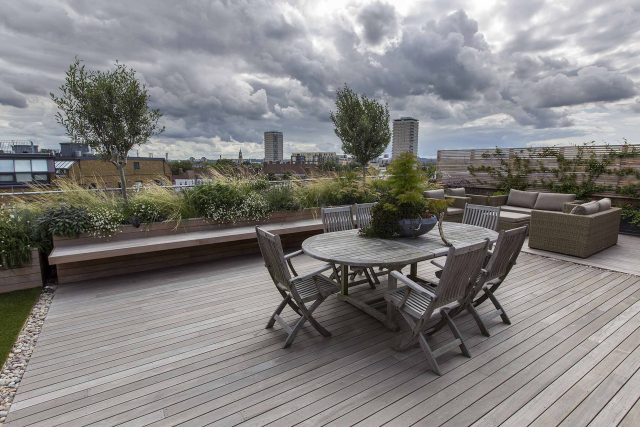 Roof terrace with decking, artificial level lawn and LED lighting design at New Concordia Wharf, highlight surfaces and architectural elements in the evenings.
