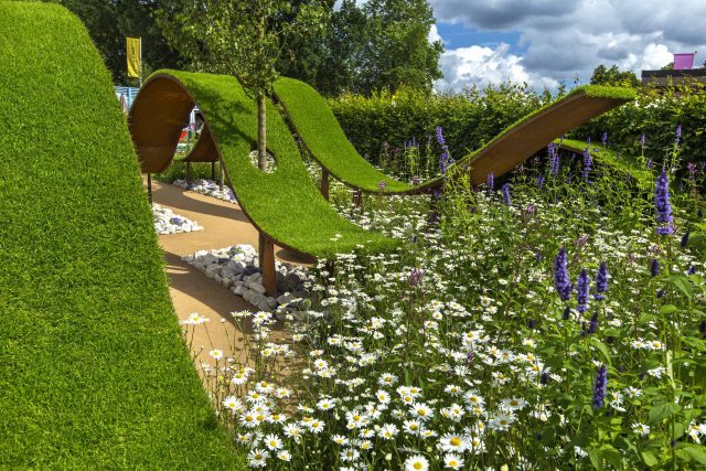 The World Vision Garden, Gold Medal Winning garden at RHS Hampton Court Palace Flower Show, The design of the garden is a horticultural interpretation London.