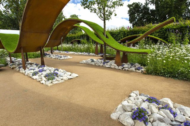 The World Vision Garden, Gold Medal Winning garden at RHS Hampton Court Palace Flower Show, The design of the garden is a horticultural interpretation London.