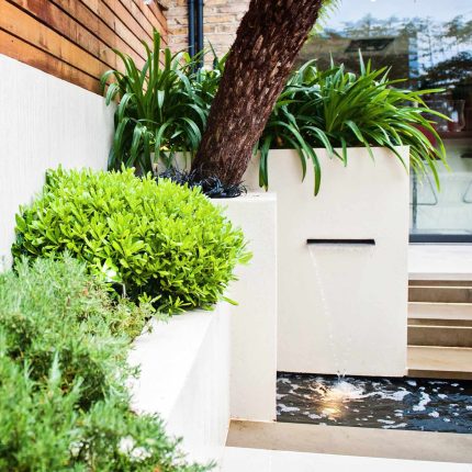 Beautiful London Garden, Clancarty Road, London, new block rendered boundary walls, planting, lighting, submersible water lights, bright contemporary effect.