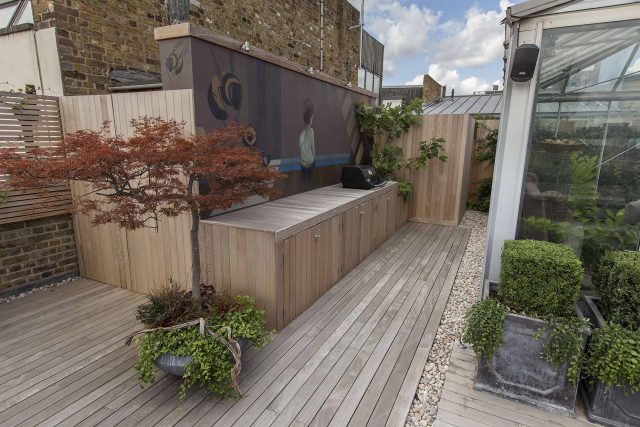 Roof terrace with decking, artificial level lawn and LED lighting design at New Concordia Wharf, highlight surfaces and architectural elements in the evenings.