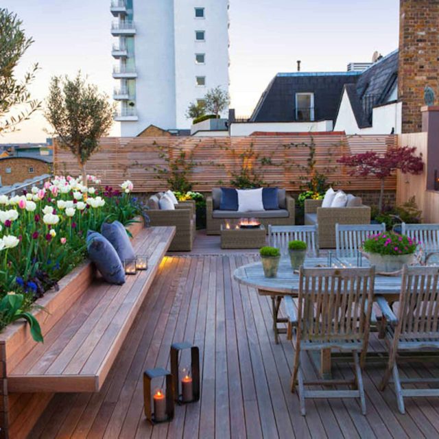 Roof terrace with decking, artificial level lawn and LED lighting design at New Concordia Wharf, highlight surfaces and architectural elements in the evenings.