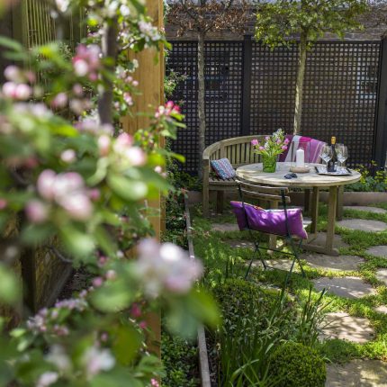 Inspirational city garden design in Holland Park London, Yorkstone stepping stones, oak posts architectural rythm to utilise lower terrace, near the basement.