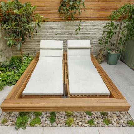 Garden design Vauxhall South London outdoor space, hidden LED strip lighting, polished white pebbles, porcelain paving steps tiles stand slatted cedar trellis.