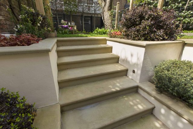 Inspirational city garden design in Holland Park London, Yorkstone stepping stones, oak posts architectural rythm to utilise lower terrace, near the basement.