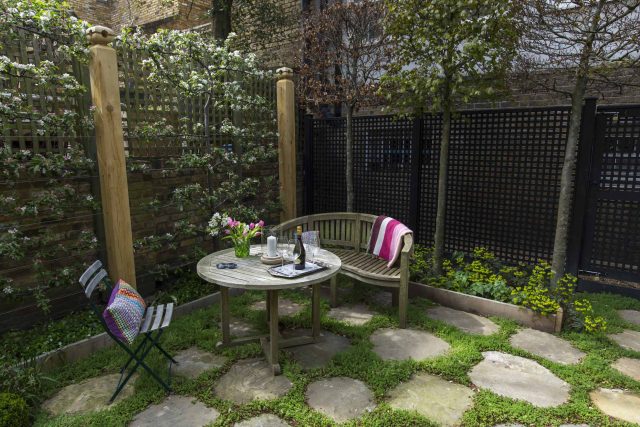 Inspirational city garden design in Holland Park London, Yorkstone stepping stones, oak posts architectural rythm to utilise lower terrace, near the basement.