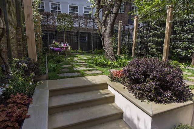 Inspirational city garden design in Holland Park London, Yorkstone stepping stones, oak posts architectural rythm to utilise lower terrace, near the basement.