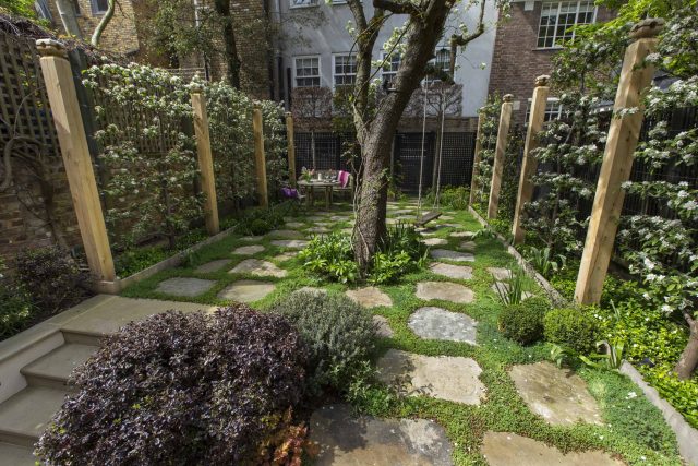 Inspirational city garden design in Holland Park London, Yorkstone stepping stones, oak posts architectural rythm to utilise lower terrace, near the basement.