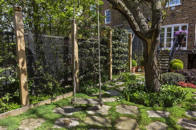 Inspirational city garden design in Holland Park London, Yorkstone stepping stones, oak posts architectural rythm to utilise lower terrace, near the basement.