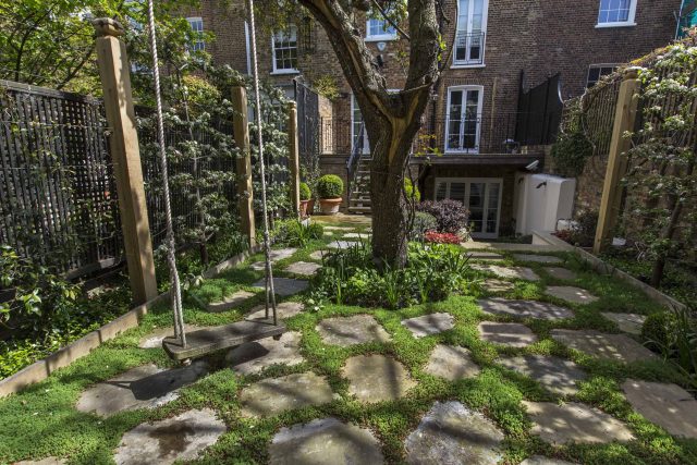 Inspirational city garden design in Holland Park London, Yorkstone stepping stones, oak posts architectural rythm to utilise lower terrace, near the basement.