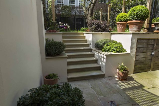 Inspirational city garden design in Holland Park London, Yorkstone stepping stones, oak posts architectural rythm to utilise lower terrace, near the basement.