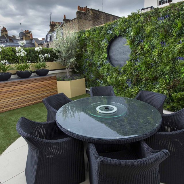Vibrant funky roof terrace with Vistafolia artificial green wall by The Garden Builders, roof garden designers slate water feature providing another chic focal.