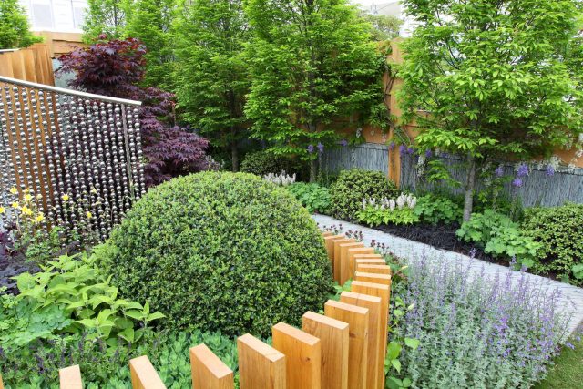 Award winning garden 2013 RHS Silver Gilt Medal at Chelsea Flower Show Garden, The Garden Builders Darren Hawkes Designer, opaque glass screens, steel balls.