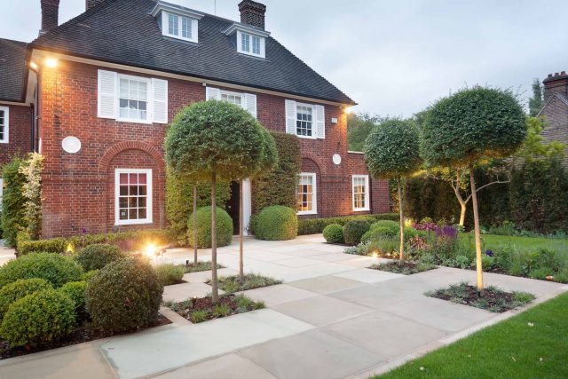 Stunning Suburban Garden constructed in Hampstead by Lynne Marcus also with Hunza exterior lighting illuminates asymmetrical landscape design, stone terrace.