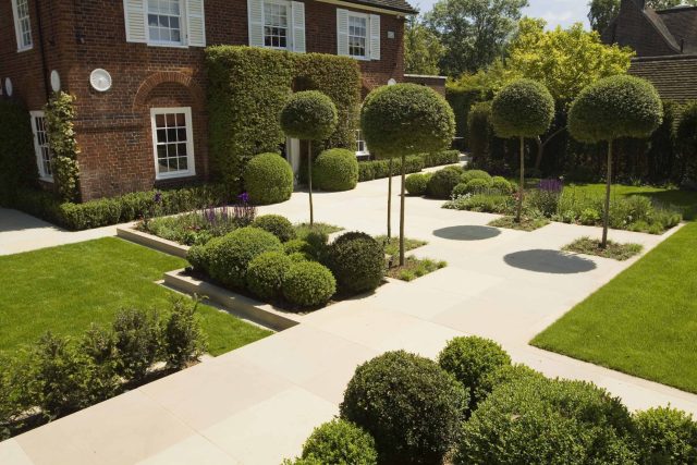 Stunning Suburban Garden constructed in Hampstead by Lynne Marcus also with Hunza exterior lighting illuminates asymmetrical landscape design, stone terrace.