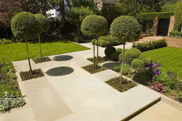 Stunning Suburban Garden constructed in Hampstead by Lynne Marcus also with Hunza exterior lighting illuminates asymmetrical landscape design, stone terrace.