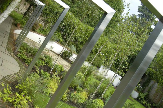 Family Garden Kent designed by Andy Sturgeon creates this Bickley garden constructed to provide a contemporary backdrop to the evergreen hedging planting.