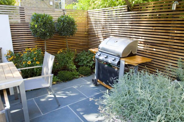 Contemporary small family garden designers in Clapham SW4 slate paving by Garden Builders London contractors near me, multi-purpose outdoor space, slate paving.