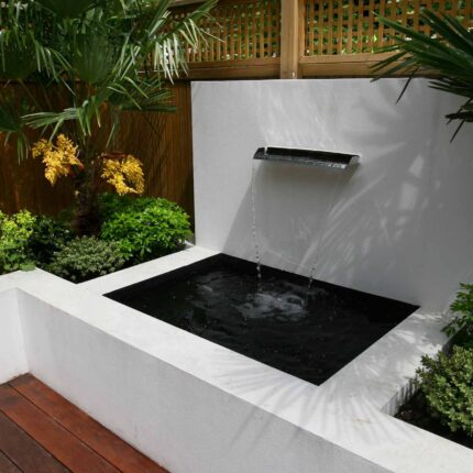 Decking design london elegant walled outdoor entertaining space Wimbledon South West London, lush planting, cozy relaxing outdoor dining area, water feature.
