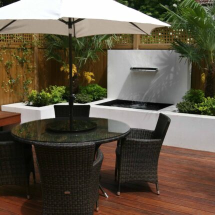 Decking design london elegant walled outdoor entertaining space Wimbledon South West London, lush planting, cozy relaxing outdoor dining area, water feature.