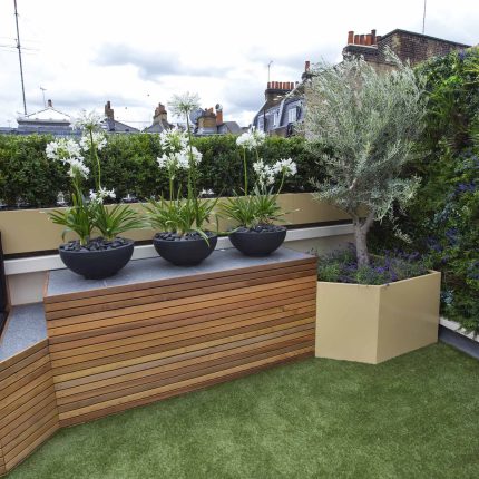 Vibrant funky roof terrace with Vistafolia artificial green wall by The Garden Builders, roof garden designers slate water feature providing another chic focal.