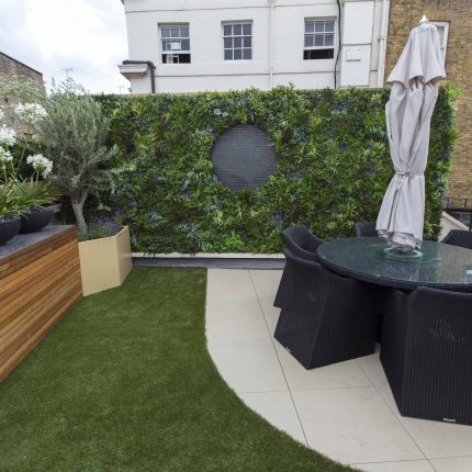 Vibrant funky roof terrace with Vistafolia artificial green wall by The Garden Builders, roof garden designers slate water feature providing another chic focal.
