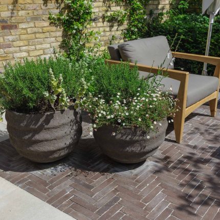 Courtyard Garden Design with an elegant walled space with Yorkstone work Fulham by The Garden Builders, canopy shade for a central lounge planted seating area.