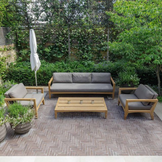 Courtyard Garden Design with an elegant walled space with Yorkstone work Fulham by The Garden Builders, canopy shade for a central lounge planted seating area.