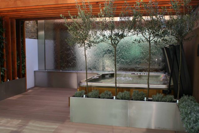 Outdoor hot tub and waterwall Garden Designs Plan Build in Central London Water feature constructed on-site along with the rear steel framework Highly Commended.