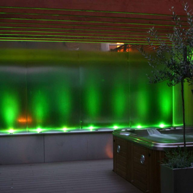 Outdoor hot tub and waterwall Garden Designs Plan Build in Central London Water feature constructed on-site along with the rear steel framework Highly Commended.