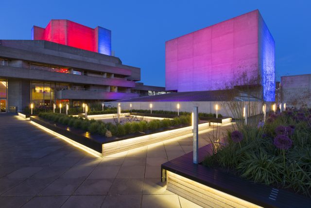 Illuminated wooden planters with alliums and grasses on the brutalist South Bank.