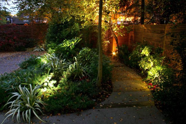 Stylish Formal Garden with terrace receives Highly Commended by Phil Frank in St John's Wood London slatted trellis panels gravel resin paths, children's play.