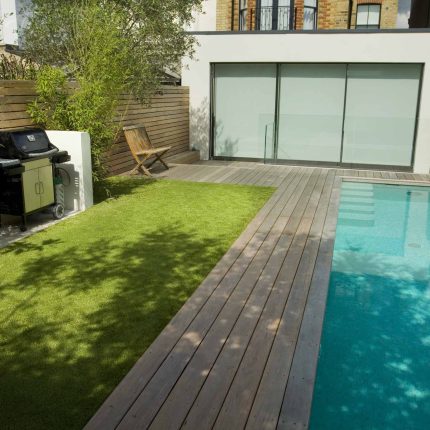 Lane swimming pool and contemporary garden designed and built by The Garden Builders Fulham London SW6, symmetry with the pool strategically planted pockets.