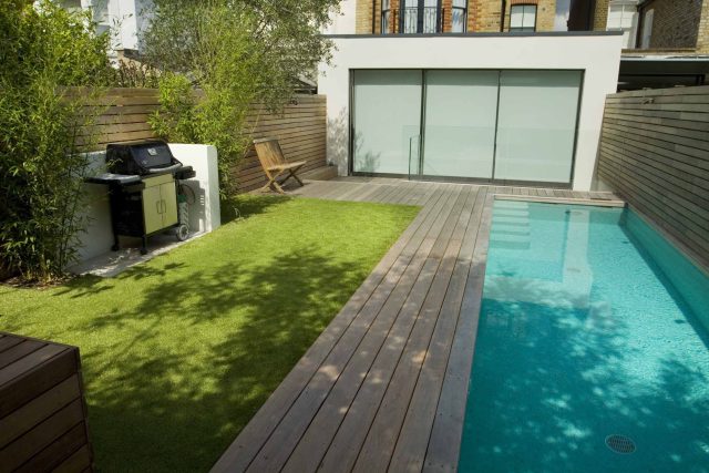 Lane swimming pool and contemporary garden designed and built by The Garden Builders Fulham London SW6, symmetry with the pool strategically planted pockets.