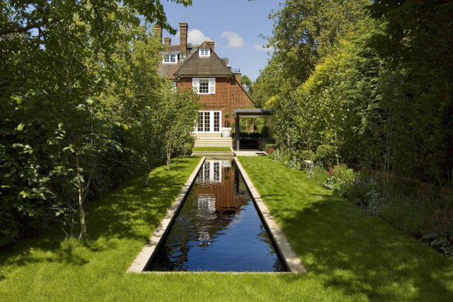 Stunning Suburban Garden constructed in Hampstead by Lynne Marcus also with Hunza exterior lighting illuminates asymmetrical landscape design, stone terrace.