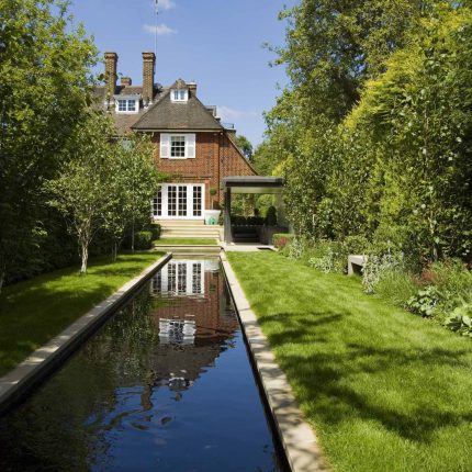 Stunning Suburban Garden constructed in Hampstead by Lynne Marcus also with Hunza exterior lighting illuminates asymmetrical landscape design, stone terrace.