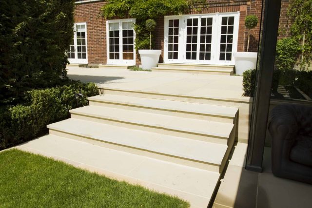 Stunning Suburban Garden constructed in Hampstead by Lynne Marcus also with Hunza exterior lighting illuminates asymmetrical landscape design, stone terrace.