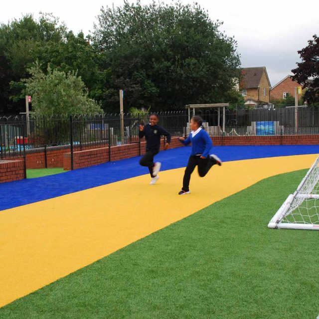 Play Zone designed by Nigel Abbey Design and landscaped by The Garden Builders, running track, play surfaces, football pitch basket ball court play zone design.