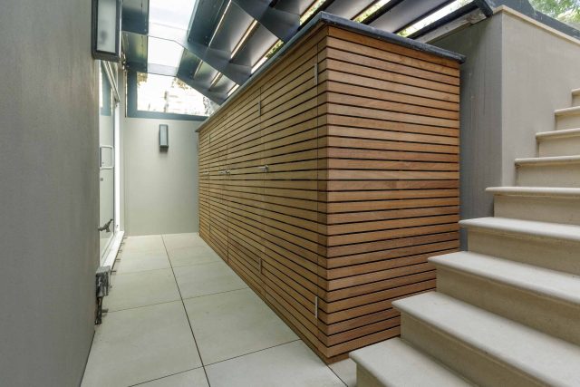 Courtyard Garden Design with an elegant walled space with Yorkstone work Fulham by The Garden Builders, canopy shade for a central lounge planted seating area.