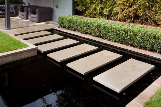 Stunning Suburban Garden constructed in Hampstead by Lynne Marcus also with Hunza exterior lighting illuminates asymmetrical landscape design, stone terrace.