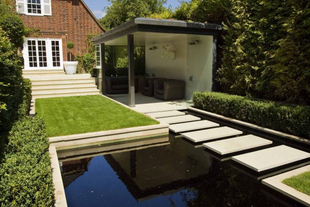 Stunning Suburban Garden constructed in Hampstead by Lynne Marcus also with Hunza exterior lighting illuminates asymmetrical landscape design, stone terrace.
