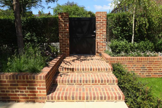 Stunning Suburban Garden constructed in Hampstead by Lynne Marcus also with Hunza exterior lighting illuminates asymmetrical landscape design, stone terrace.