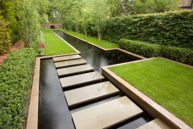 Stunning Suburban Garden constructed in Hampstead by Lynne Marcus also with Hunza exterior lighting illuminates asymmetrical landscape design, stone terrace.