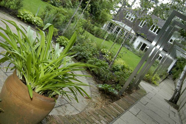 Family Garden Kent designed by Andy Sturgeon creates this Bickley garden constructed to provide a contemporary backdrop to the evergreen hedging planting.