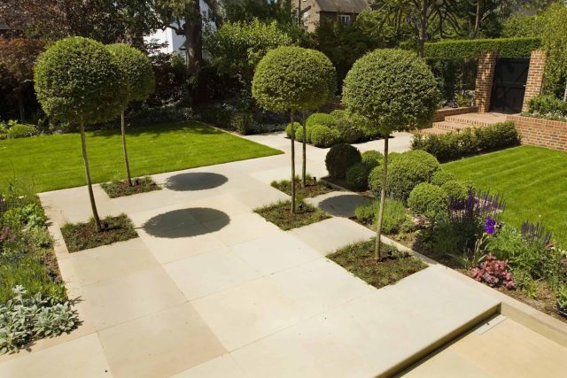Stunning Suburban Garden constructed in Hampstead by Lynne Marcus also with Hunza exterior lighting illuminates asymmetrical landscape design, stone terrace.